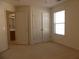 Bedroom features neutral carpet, large closet doors, and natural light from a window at 158 Weatherstone Dr, Woodstock, GA 30188