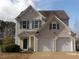 Charming two-story home featuring a two-car garage and well-manicured landscaping at 158 Weatherstone Dr, Woodstock, GA 30188