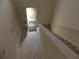 Foyer features tile, a carpeted staircase, and an open door at 158 Weatherstone Dr, Woodstock, GA 30188