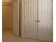 Hallway featuring carpet, a bedroom door, and multiple closet doors at 158 Weatherstone Dr, Woodstock, GA 30188