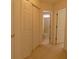 Hallway with folding closet doors and access to the bathroom at 158 Weatherstone Dr, Woodstock, GA 30188