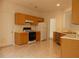 Bright kitchen with wood cabinets, modern appliances, and neutral countertops at 158 Weatherstone Dr, Woodstock, GA 30188