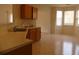 Eat-in kitchen featuring oak cabinets, laminate countertops, and a bright breakfast nook at 158 Weatherstone Dr, Woodstock, GA 30188