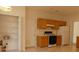 Kitchen featuring wood cabinets and modern appliances next to a pantry and door at 158 Weatherstone Dr, Woodstock, GA 30188