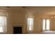 Bright living room featuring a fireplace, neutral carpet, and access to the backyard at 158 Weatherstone Dr, Woodstock, GA 30188