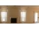 Bright living room featuring a fireplace, neutral carpet, and access to the backyard at 158 Weatherstone Dr, Woodstock, GA 30188
