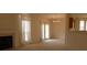 Spacious living room with neutral carpet, a fireplace, and access to the backyard at 158 Weatherstone Dr, Woodstock, GA 30188