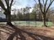 Community tennis court featuring mature trees for shade around the perimeter at 158 Weatherstone Dr, Woodstock, GA 30188