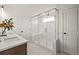 Modern bathroom with a glass-enclosed shower, dual sinks, and white tile at 1605 Wander Ml, Cumming, GA 30040