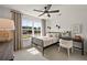 Charming bedroom featuring an iron bed frame, ceiling fan, and ample natural light from a large window at 1605 Wander Ml, Cumming, GA 30040