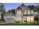 Charming two-story home boasts craftsman-style details, neutral tones, and lush front lawn at 1605 Wander Ml, Cumming, GA 30040