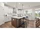 Gourmet kitchen with white cabinetry, stainless steel appliances and a breakfast bar at 1605 Wander Ml, Cumming, GA 30040