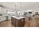 Open kitchen and living room featuring a large island, stainless appliances, and hardwood floors at 1605 Wander Ml, Cumming, GA 30040