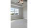 Cozy bedroom with neutral carpeting, large windows and ceiling fan at 38 Lakeview Pt, Dallas, GA 30157