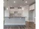 Well-lit kitchen with a large center island, granite countertops, and stylish cabinetry at 38 Lakeview Pt, Dallas, GA 30157