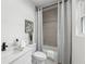 Elegant bathroom featuring modern fixtures, a shower-tub combo, and neutral décor at 727 Garibaldi Sw St, Atlanta, GA 30310
