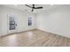Bright bedroom featuring wood floors, a modern ceiling fan, and balcony access at 727 Garibaldi Sw St, Atlanta, GA 30310