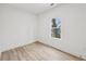 A bedroom featuring wood-look floors, and a window with a tree-filled view at 727 Garibaldi Sw St, Atlanta, GA 30310