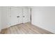 Bright bedroom featuring neutral walls, hardwood flooring, and double door closets at 727 Garibaldi Sw St, Atlanta, GA 30310