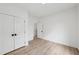 A bedroom featuring wood-look floors, double closet, and a hallway doorway at 727 Garibaldi Sw St, Atlanta, GA 30310