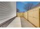 A view of the side of the home with a new driveway that goes to a privacy fence at 727 Garibaldi Sw St, Atlanta, GA 30310