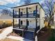 Stunning new construction featuring a double porch with black railings and a modern, light-filled design at 727 Garibaldi Sw St, Atlanta, GA 30310