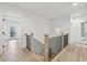 Upstairs hallway with a wood and iron railing and view of the outdoor covered porch at 727 Garibaldi Sw St, Atlanta, GA 30310
