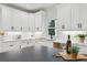 A kitchen with a kitchen island, stainless appliances, and a wine bottle and wine glass at 727 Garibaldi Sw St, Atlanta, GA 30310