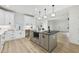 A kitchen with a kitchen island, stainless appliances, and modern lighting at 727 Garibaldi Sw St, Atlanta, GA 30310