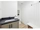 Elegant powder room featuring a modern vanity with a dark countertop, alongside a built-in bench at 727 Garibaldi Sw St, Atlanta, GA 30310