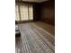 The living room features wood paneled walls, wall-to-wall carpet, and a large window at 110 Casa Domain Ct, South Fulton, GA 30349