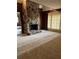 Living room showcasing a floor-to-ceiling stone fireplace, wood paneling, and neutral carpet at 110 Casa Domain Ct, South Fulton, GA 30349