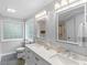 This bright bathroom features a double sink vanity with two mirrors and modern lighting at 144 Wyckliffe Dr, Locust Grove, GA 30248