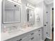 This bright bathroom features a double sink vanity with two mirrors and modern lighting at 144 Wyckliffe Dr, Locust Grove, GA 30248