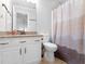 Bright bathroom featuring a modern vanity with granite countertop, white cabinets, toilet, and shower with curtain at 144 Wyckliffe Dr, Locust Grove, GA 30248