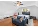 Bedroom area with a couch, bed, hardwood floors, and comfortable ambiance for relaxation at 144 Wyckliffe Dr, Locust Grove, GA 30248