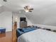 Spacious bedroom area with a couch, dresser, hardwood floors, and comfortable ambiance for relaxation at 144 Wyckliffe Dr, Locust Grove, GA 30248