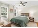 Well-lit bedroom featuring a comfortable bed, stylish nightstands, with hardwood floors and soft natural lighting at 144 Wyckliffe Dr, Locust Grove, GA 30248