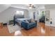 Spacious bedroom area with a couch, desk, hardwood floors, and comfortable ambiance for relaxation at 144 Wyckliffe Dr, Locust Grove, GA 30248