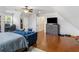 Spacious bedroom area with a couch, dresser, hardwood floors, and comfortable ambiance for relaxation at 144 Wyckliffe Dr, Locust Grove, GA 30248