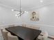 Elegant dining room featuring contemporary lighting and a spacious dining table at 144 Wyckliffe Dr, Locust Grove, GA 30248