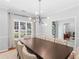 Bright dining room showcasing a contemporary chandelier and classic design details at 144 Wyckliffe Dr, Locust Grove, GA 30248