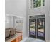 Grand foyer with soaring ceilings, black french doors, and an elegant dining room at 144 Wyckliffe Dr, Locust Grove, GA 30248