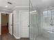The tiled glass shower features a rainfall shower head, shower seat and inset shelves at 144 Wyckliffe Dr, Locust Grove, GA 30248