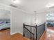 Upstairs hallway with decorative lighting and views into two bedrooms at 144 Wyckliffe Dr, Locust Grove, GA 30248