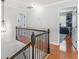 Hallway with wrought iron banister and views to rooms and the stairs at 144 Wyckliffe Dr, Locust Grove, GA 30248