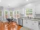 Eat-in kitchen with stainless appliances, granite counters, tile backsplash, and hardwood floors at 144 Wyckliffe Dr, Locust Grove, GA 30248