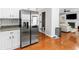 Open kitchen featuring stainless steel appliances, bright cabinets, and hardwood flooring at 144 Wyckliffe Dr, Locust Grove, GA 30248