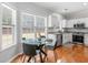 Eat-in kitchen featuring a modern glass table, stainless steel appliances, and lots of natural light at 144 Wyckliffe Dr, Locust Grove, GA 30248