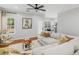 Bright living room with fireplace, large sectional, hardwood flooring, and peaceful buddha at 144 Wyckliffe Dr, Locust Grove, GA 30248